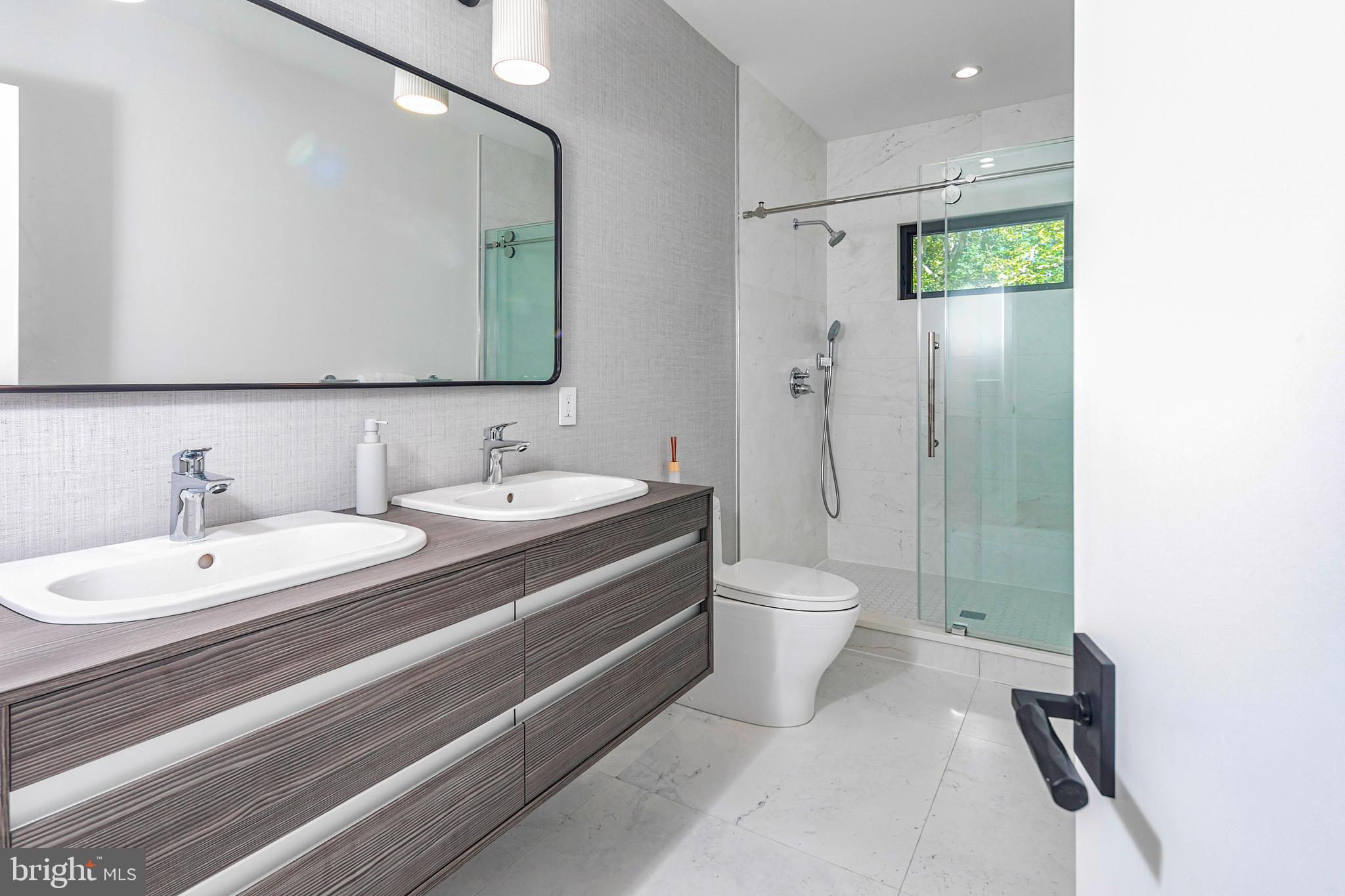 44 Armour Road Princeton, NJ 08540 - Photo 33 of 51 a bathroom with a double vanity sink toilet mirror and shower