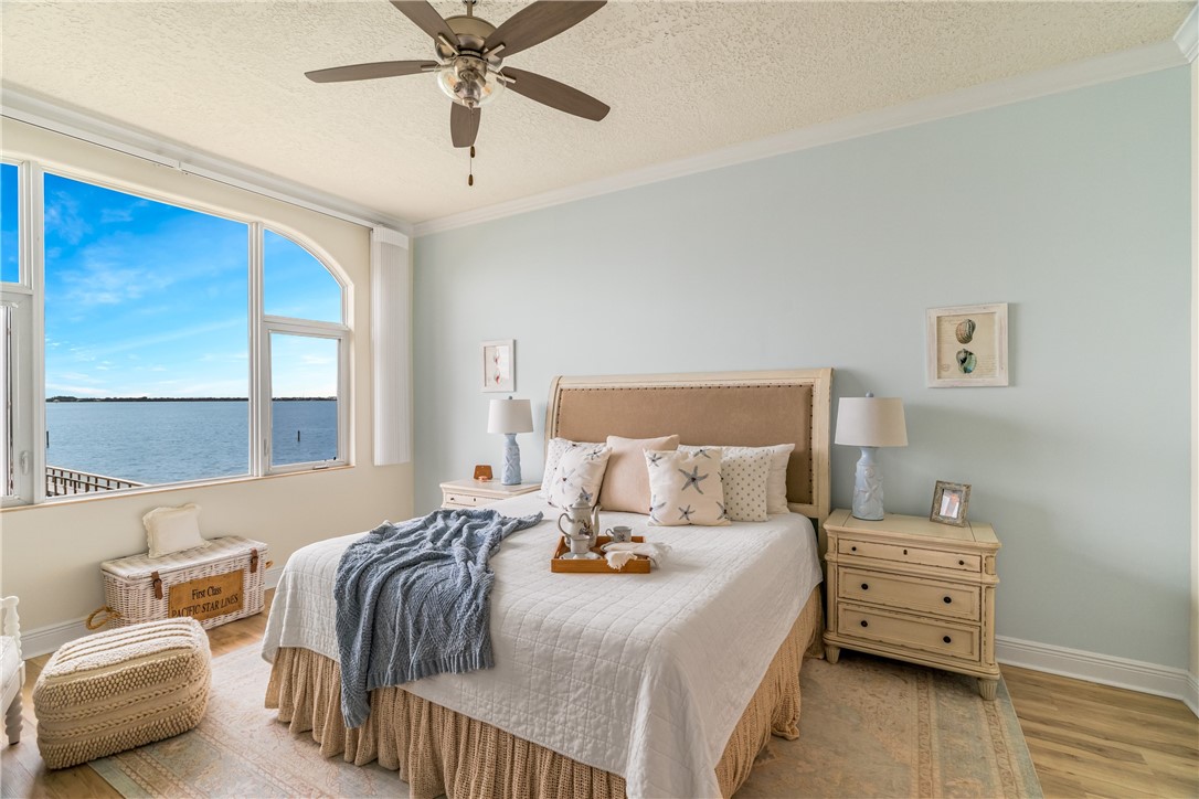 1701 Gulfstream Avenue, Unit 729 Fort Pierce, FL 34949 - Photo 19 of 36 a bedroom with a bed and wooden floor