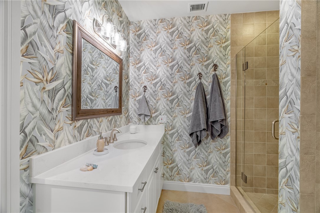 1701 Gulfstream Avenue, Unit 729 Fort Pierce, FL 34949 - Photo 23 of 36 a bathroom with a sink and mirror with shower