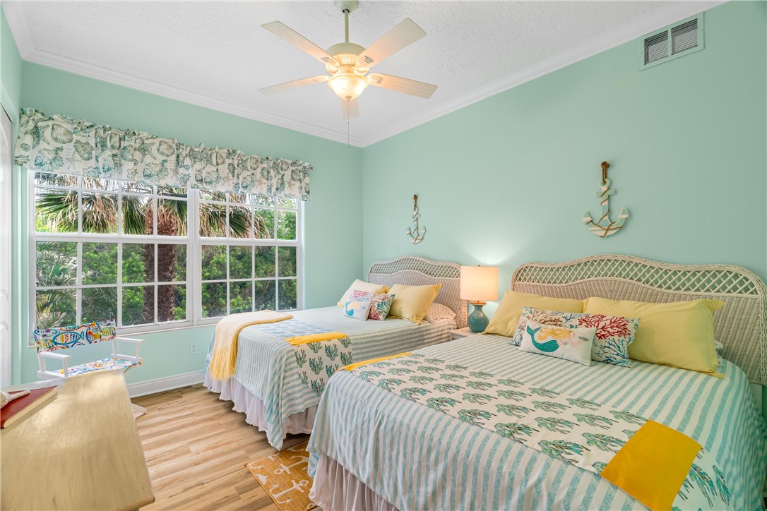 1701 Gulfstream Avenue, Unit 729 Fort Pierce, FL 34949 - Photo 27 of 36 a bedroom with two beds and a large window