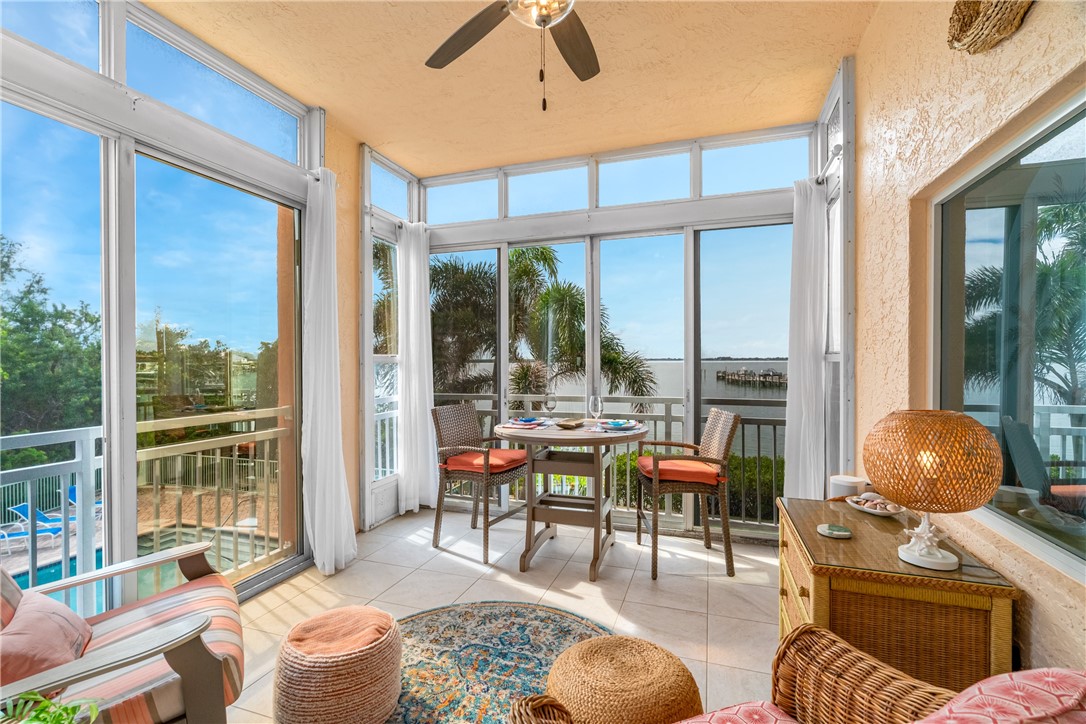 1701 Gulfstream Avenue, Unit 729 Fort Pierce, FL 34949 - Photo 30 of 36 a living room with furniture and floor to ceiling windows