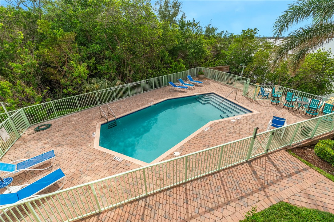 1701 Gulfstream Avenue, Unit 729 Fort Pierce, FL 34949 - Photo 35 of 36 a view of a tennis ground with large trees