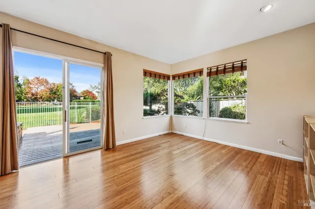 a large kitchen with cabinets wooden floor and stainless steel appliances