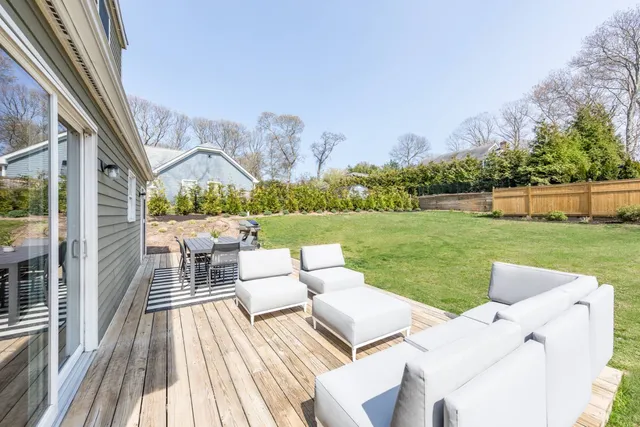 a view of yard from terrace with seating area