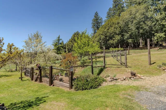 a backyard of a house with barbeque oven and outdoor seating