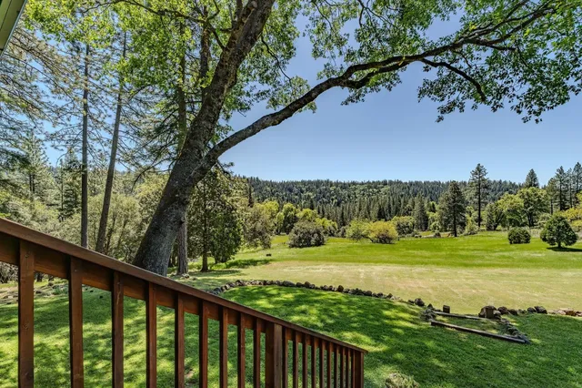 a backyard of a house with barbeque oven and outdoor seating