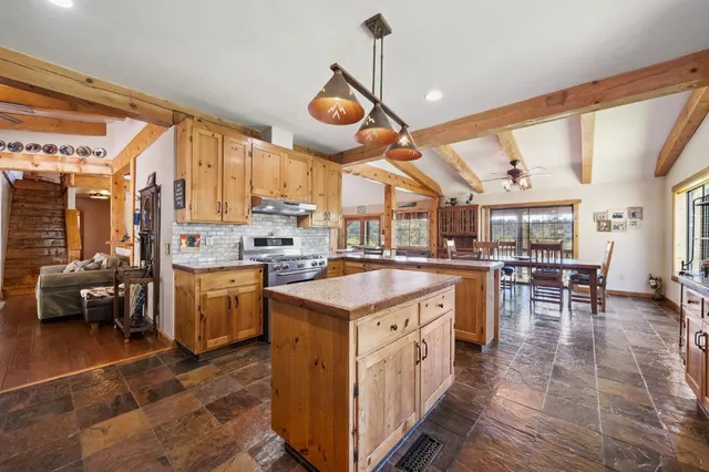 a spacious bathroom with a granite countertop sink a toilet and a mirror