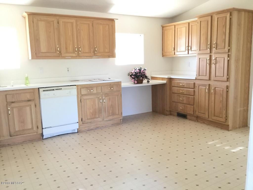 7420 West Bopp Road Tucson, AZ 85735 - Photo 32 of 39 a kitchen with granite countertop cabinets and window