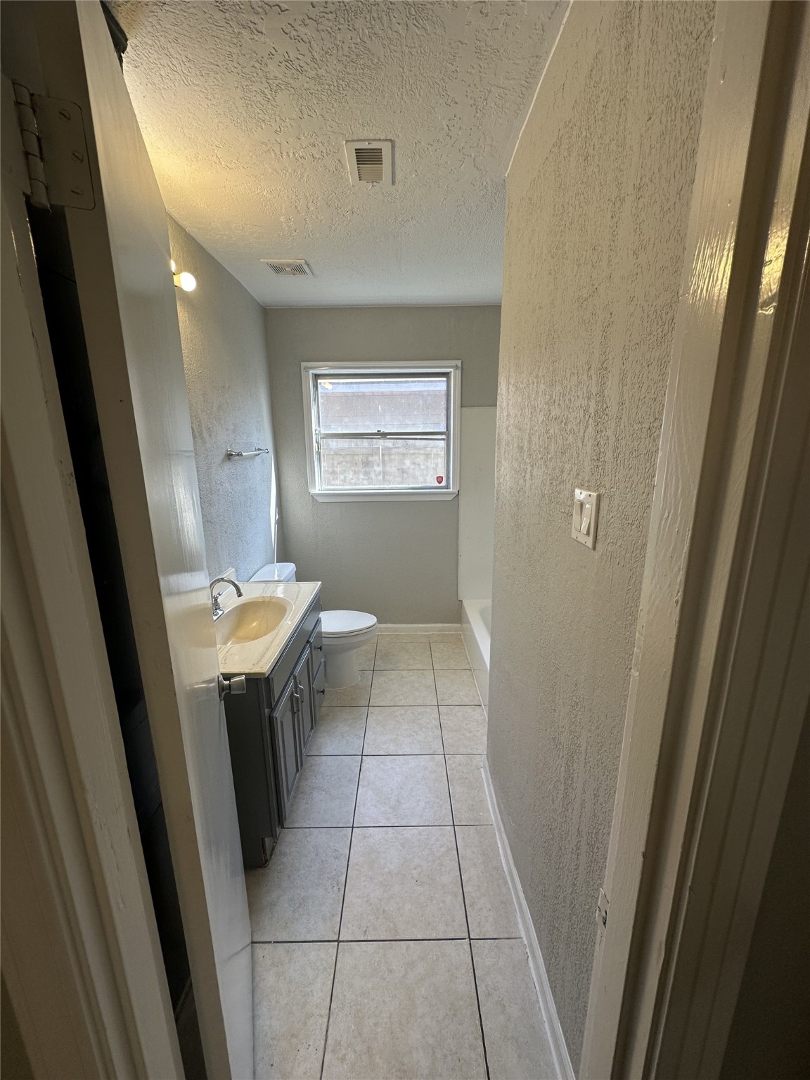 5847 Belcrest Street Houston, TX 77033 - Photo 5 of 7 a view of bathroom with a sink a toilet and shower
