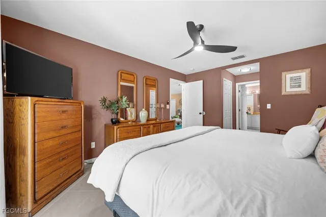 a bedroom with a bed and a flat tv screen