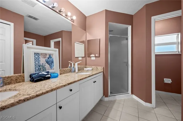 a bathroom with a granite countertop sink a mirror and a