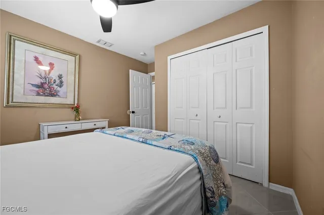 a bedroom with a bed and a painting on the wall