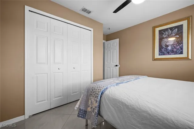 a bedroom with a bed and a painting on the wall