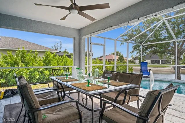 a view of a patio with a dining table and chairs