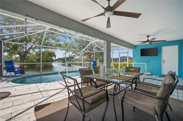 a view of a patio with dining table and chairs