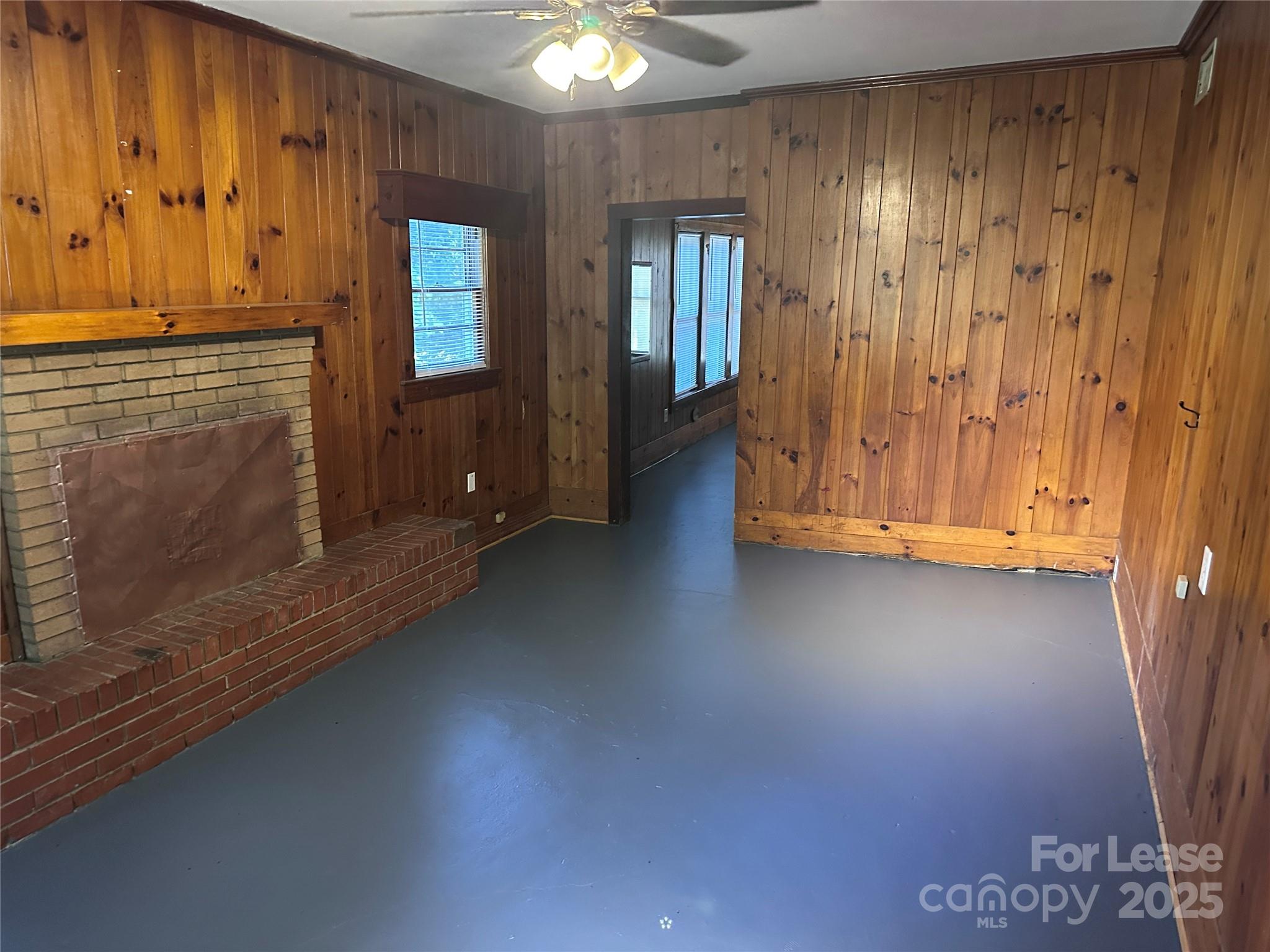 9155 601st Highway Midland, NC 28107 - Photo 12 of 14 wooden floor in an empty room with a fireplace