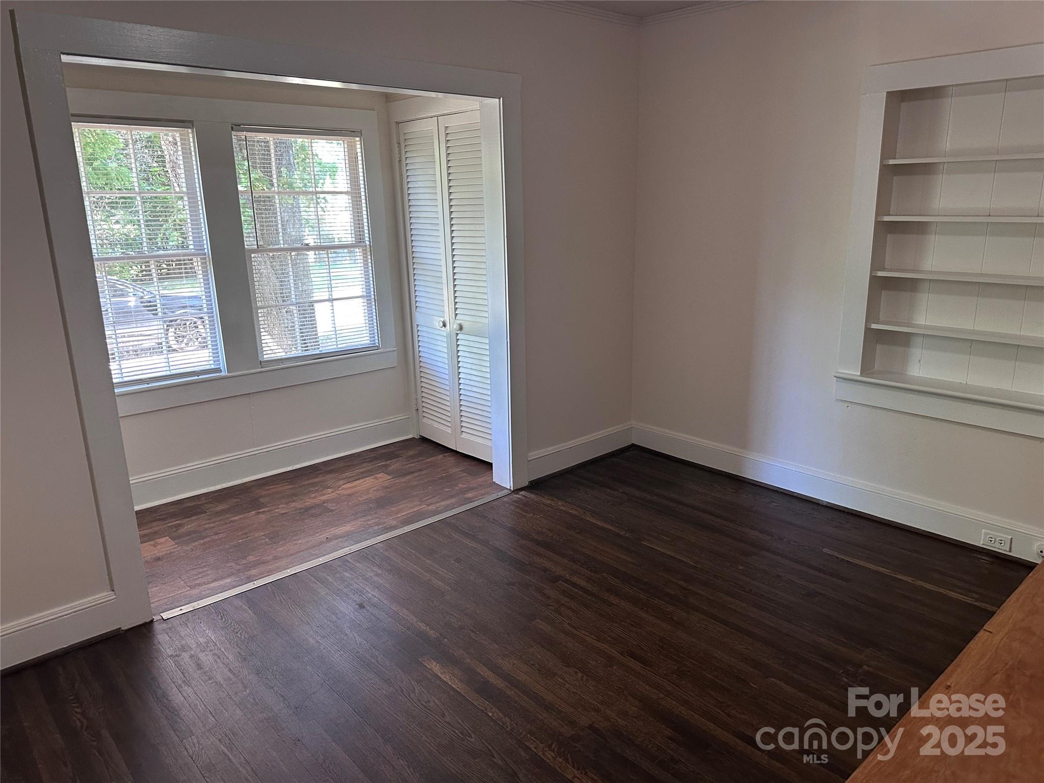 9155 601st Highway Midland, NC 28107 - Photo 7 of 14 a view of an empty room with wooden floor and a window