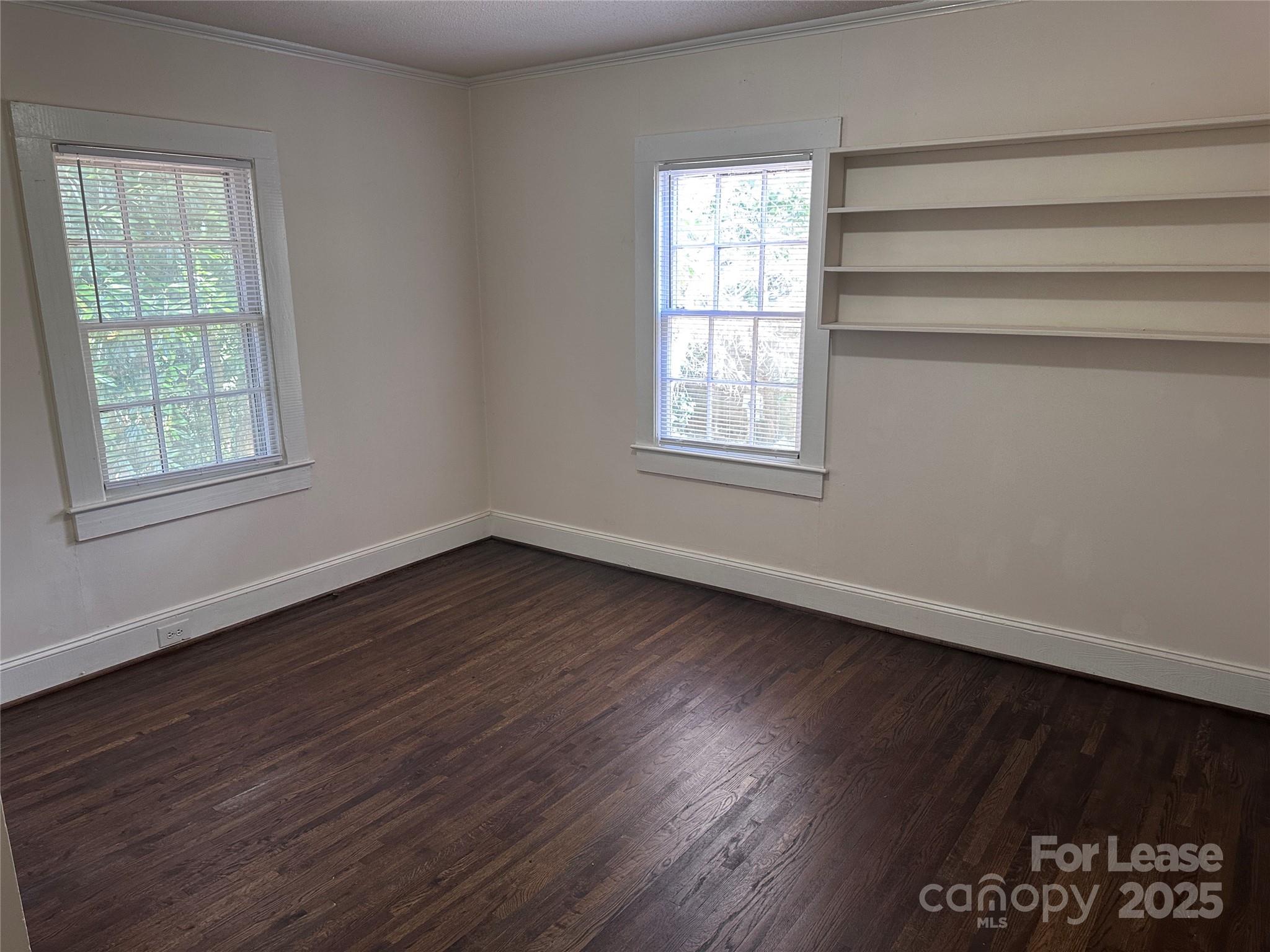 9155 601st Highway Midland, NC 28107 - Photo 8 of 14 an empty room with wooden floor and windows