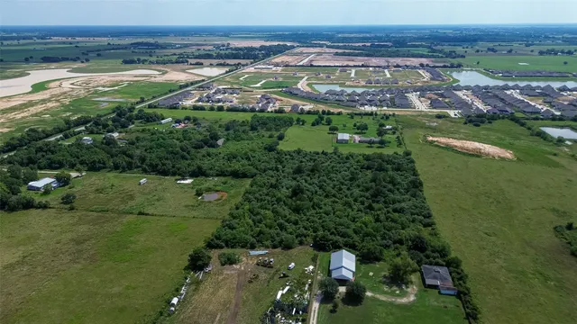 an aerial view of a houses with a yard