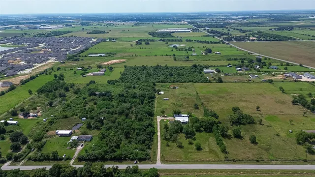an aerial view of huge green field with lots of green plants and fog