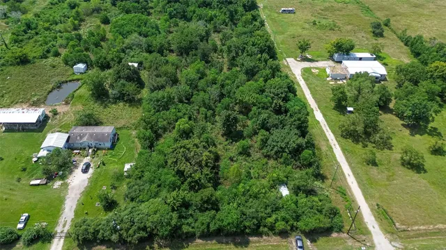 a view of a field and trees