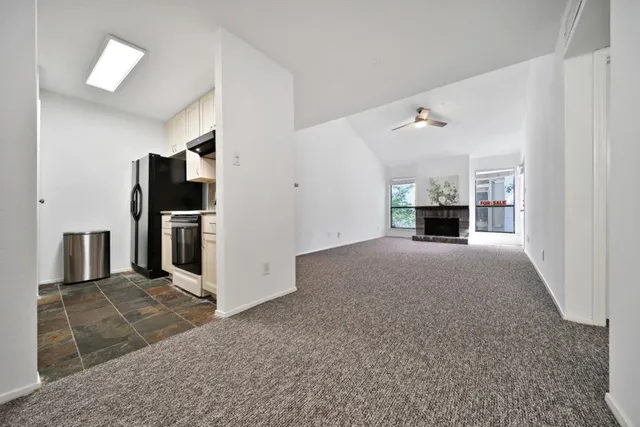 a view of kitchen with refrigerator stove microwave and cabinets