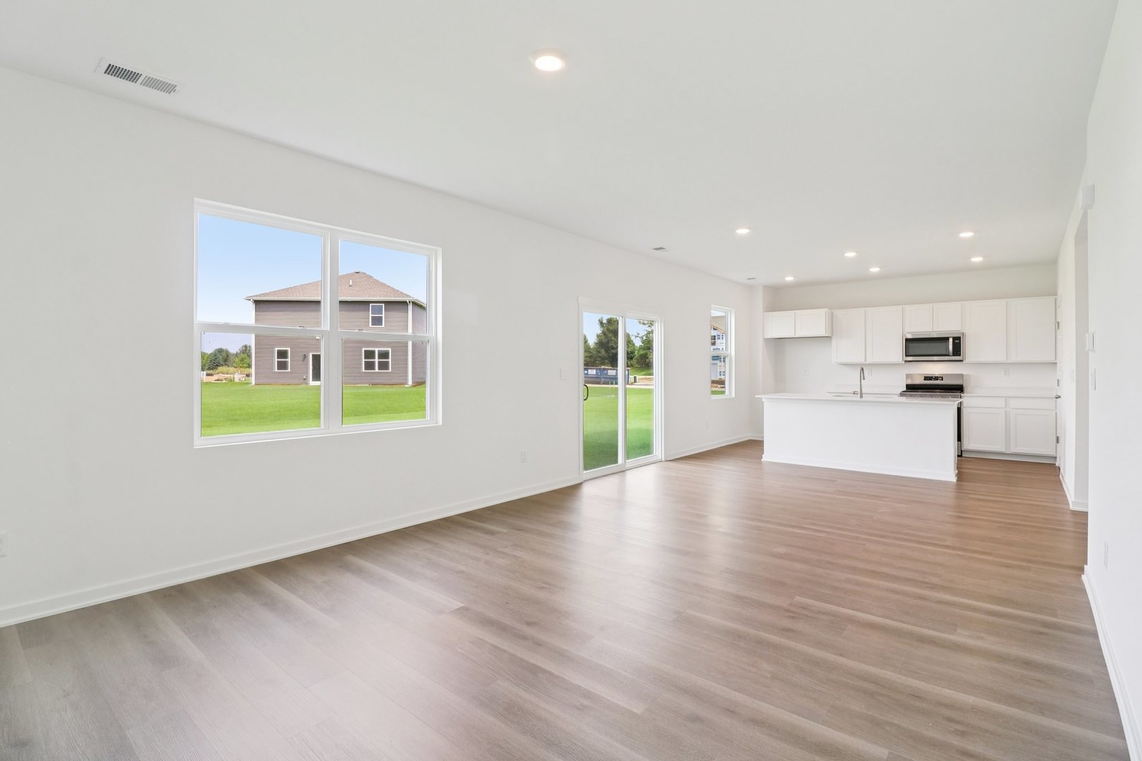 9956 Edgebrook Lane Huntley, IL 60142 - Photo 7 of 29 a view of a kitchen with a sink a refrigerator and a stove top oven