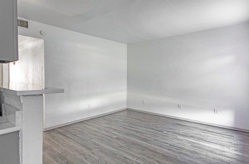 916 Isbell Road, Unit D Fort Worth, TX 76114 - Photo 3 of 13 wooden floor in an empty room