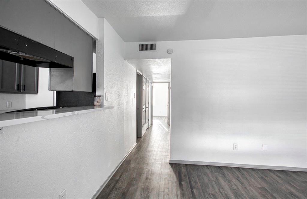916 Isbell Road, Unit D Fort Worth, TX 76114 - Photo 5 of 13 a view of a refrigerator in kitchen and wooden floor