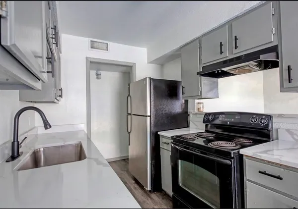 a kitchen with a stove microwave and refrigerator