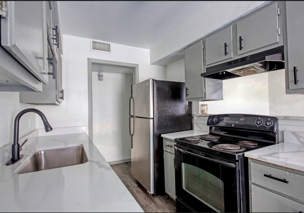 916 Isbell Road, Unit D Fort Worth, TX 76114 - Photo 8 of 13 a kitchen with a stove microwave and refrigerator