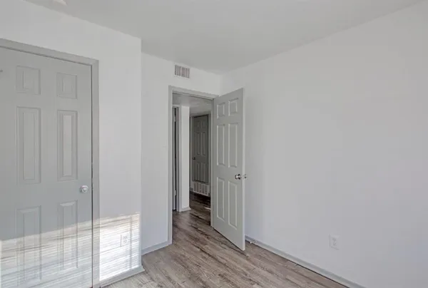 a view of a hallway with wooden floor