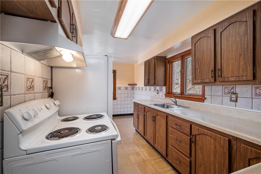 7510 Noblestown Road McDonald, PA 15057 - Photo 4 of 20 a kitchen with a sink a stove and cabinets
