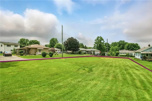 a view of yard with swimming pool and green space