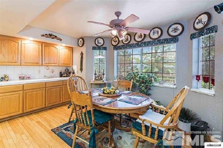 1668 East Valley Road Gardnerville, NV 89410 - Photo 5 of 22 a view of a dining room with furniture window and wooden floor
