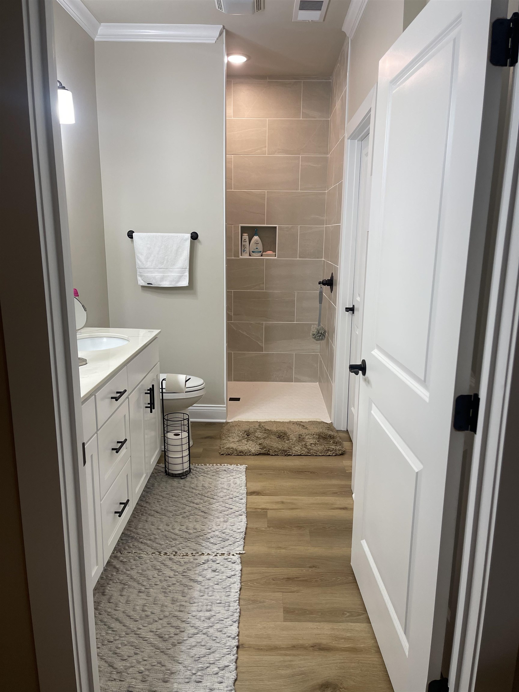 210 Church Street Ripley, TN 38063 - Photo 13 of 21 Full bathroom featuring vanity, a walk in shower, light wood-style flooring, and ornamental molding
