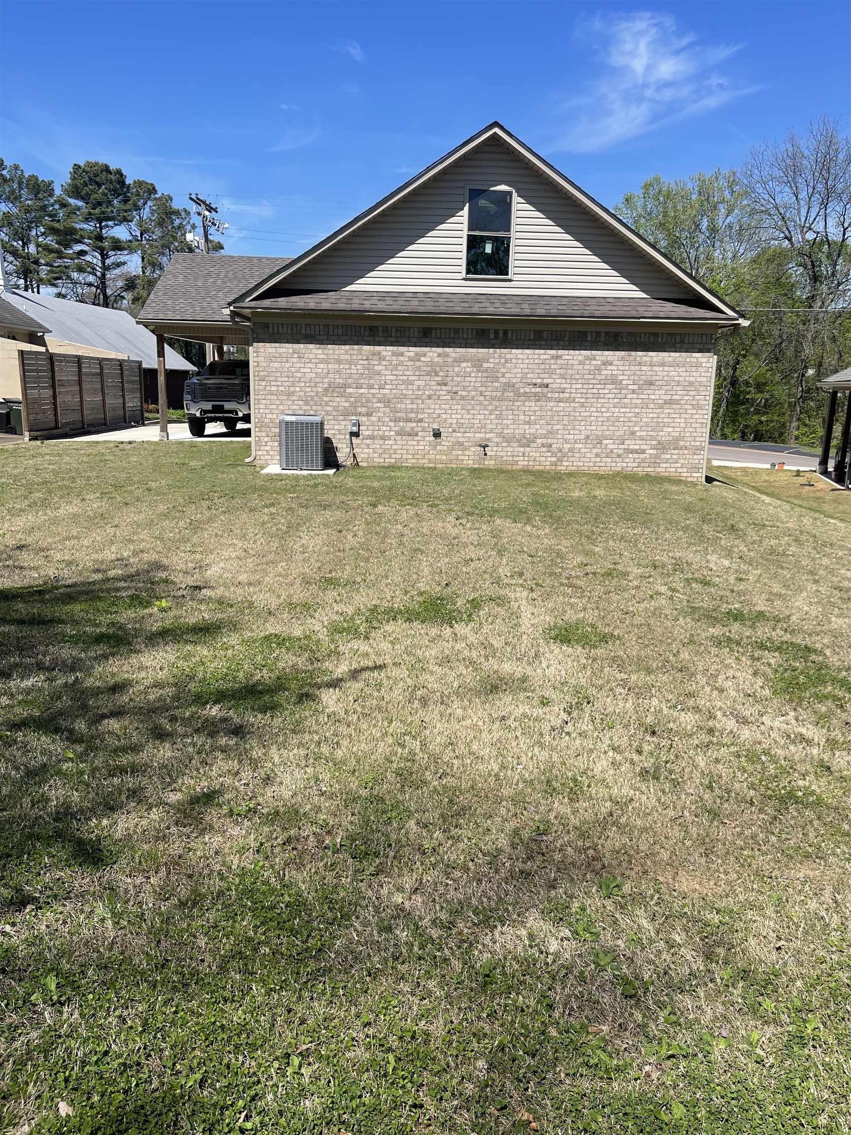 210 Church Street Ripley, TN 38063 - Photo 2 of 21 View of property exterior featuring brick siding and a lawn