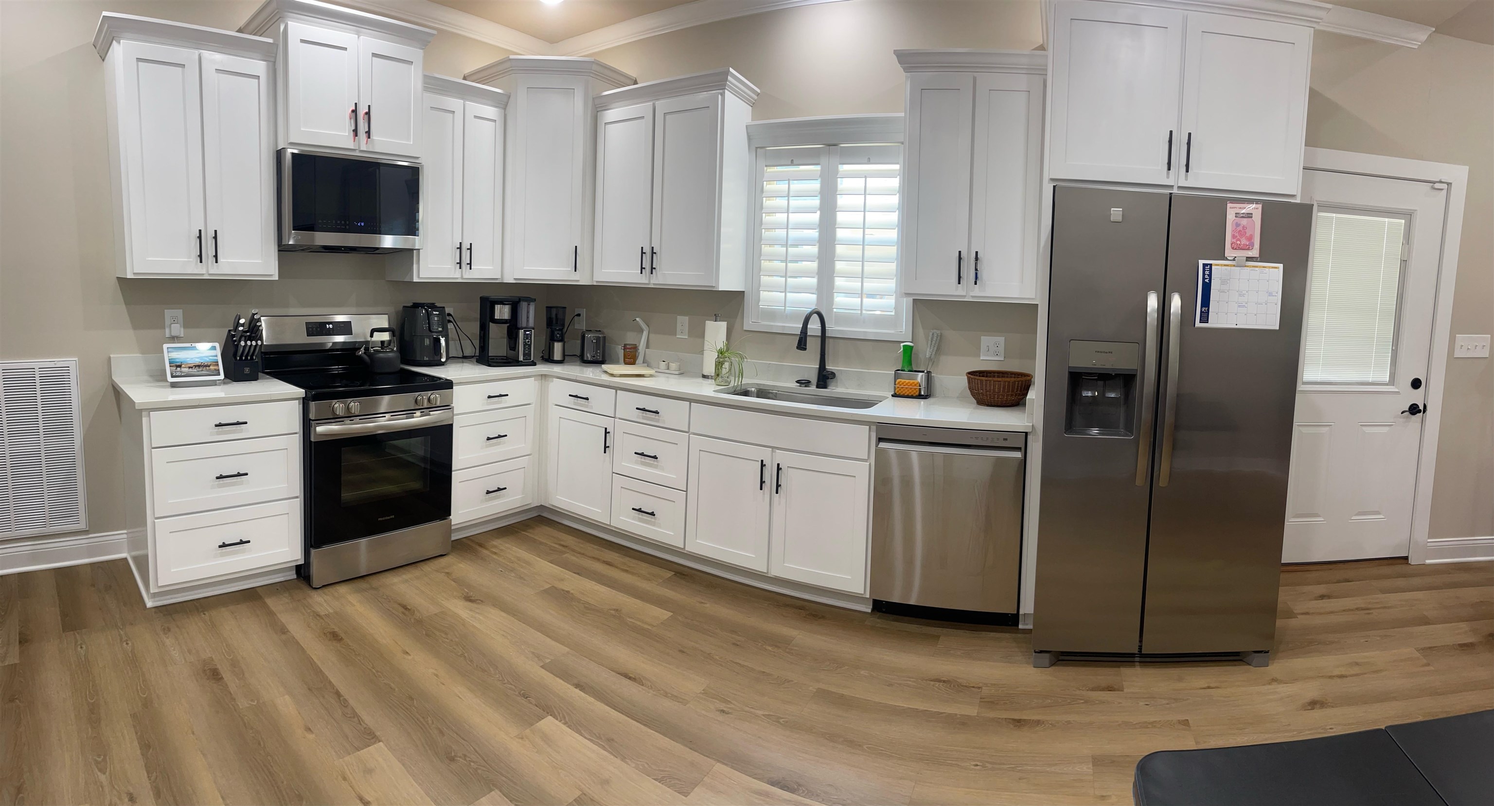 210 Church Street Ripley, TN 38063 - Photo 6 of 21 Kitchen with stainless steel appliances, white cabinets, ornamental molding, light wood-style floors, and recessed lighting
