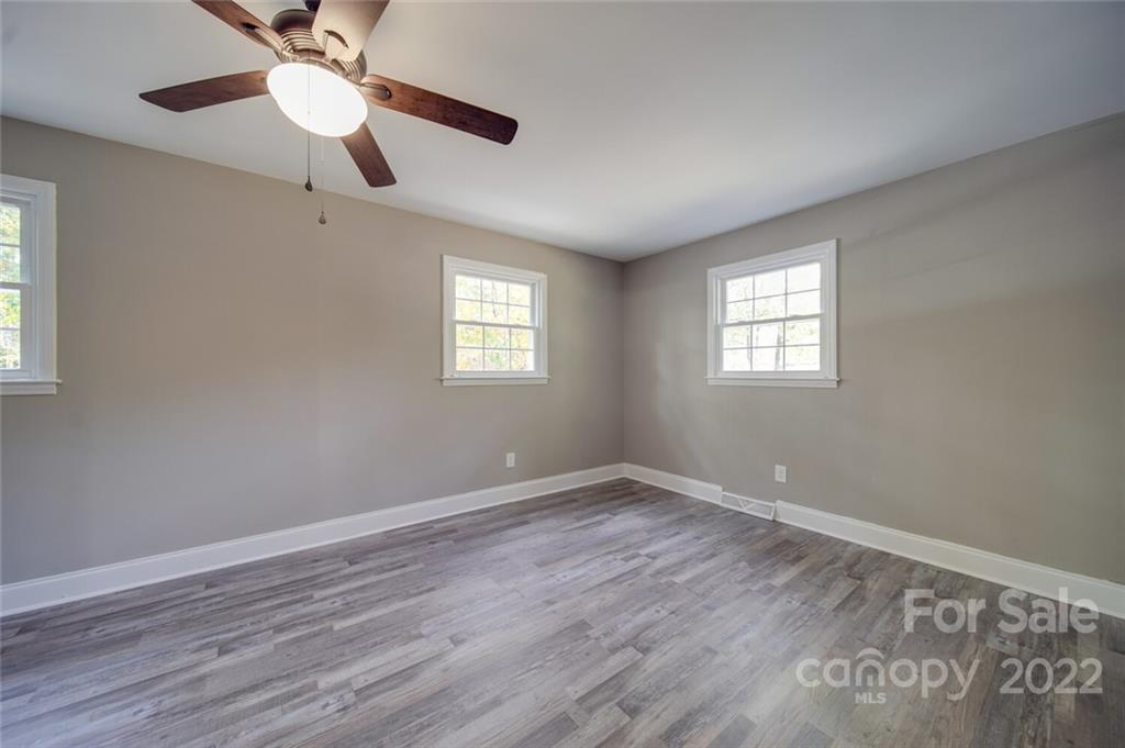 1149 Long Pine Church Road Peachland, NC 28133 - Photo 12 of 27 a view of an empty room with a window and wooden floor