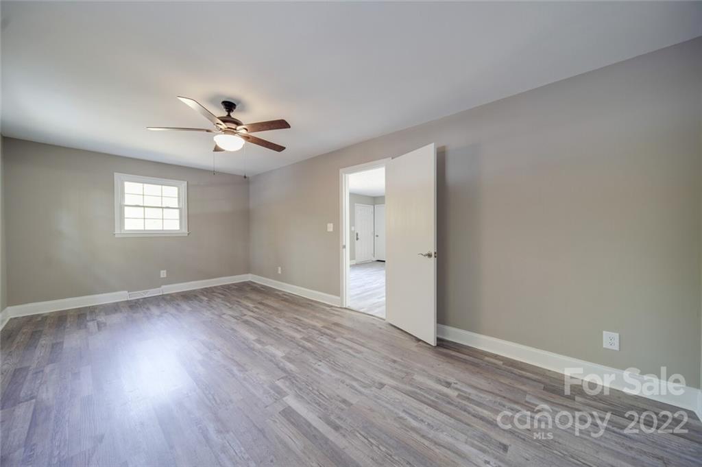 1149 Long Pine Church Road Peachland, NC 28133 - Photo 13 of 27 a view of an empty room with wooden floor and a window