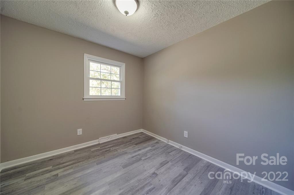 1149 Long Pine Church Road Peachland, NC 28133 - Photo 16 of 27 an empty room with wooden floor and windows