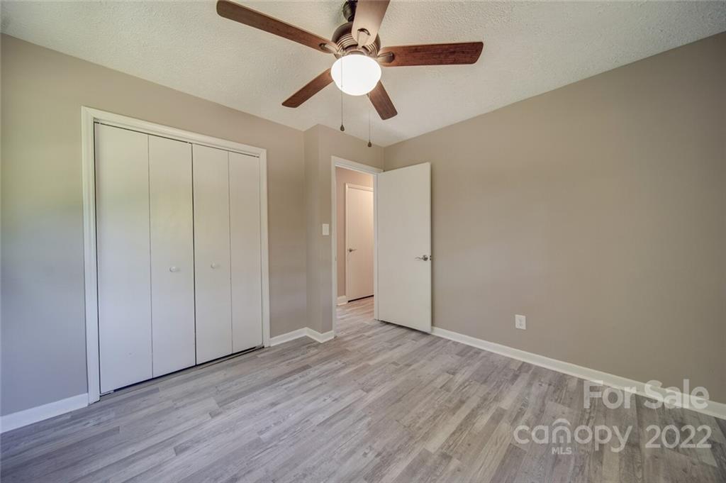 1149 Long Pine Church Road Peachland, NC 28133 - Photo 19 of 27 an empty room with wooden floor fan and windows