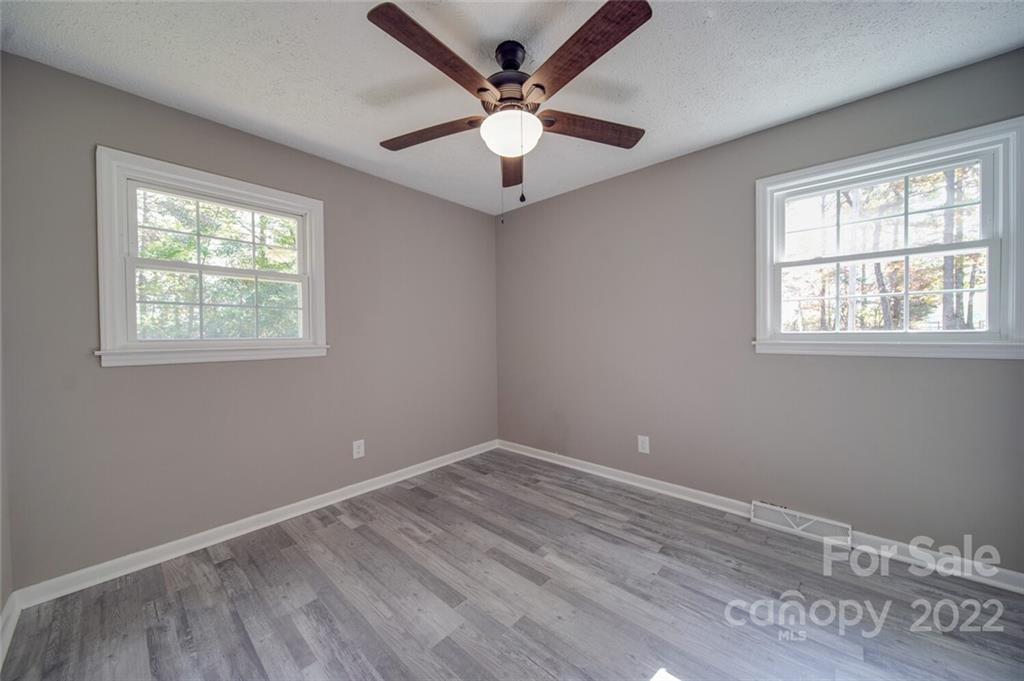 1149 Long Pine Church Road Peachland, NC 28133 - Photo 20 of 27 a view of an empty room with wooden floor and a window
