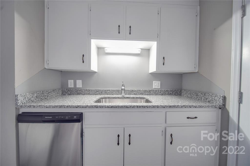 1149 Long Pine Church Road Peachland, NC 28133 - Photo 6 of 27 a kitchen with granite countertop white cabinets and a sink