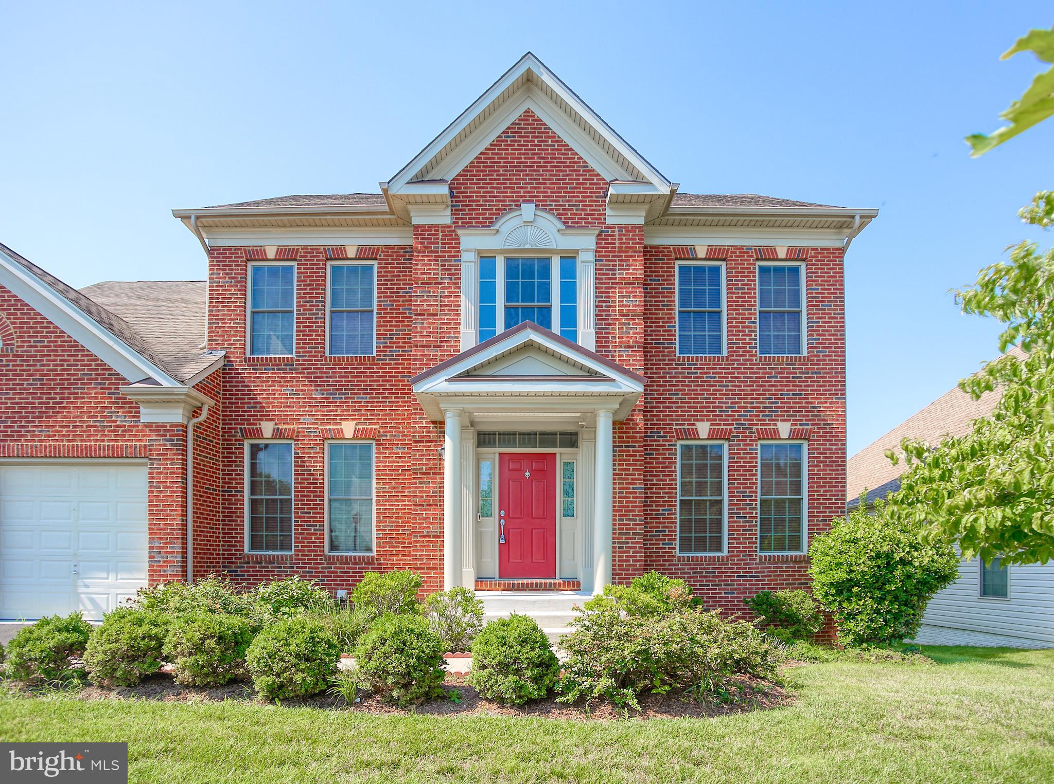 front view of brick house with a yard