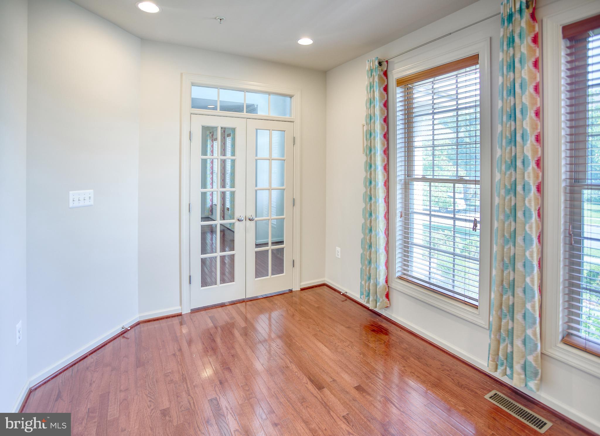 13336 Redspire Drive Silver Spring, MD 20906 - Photo 11 of 66 a view of an empty room with wooden floor and a window