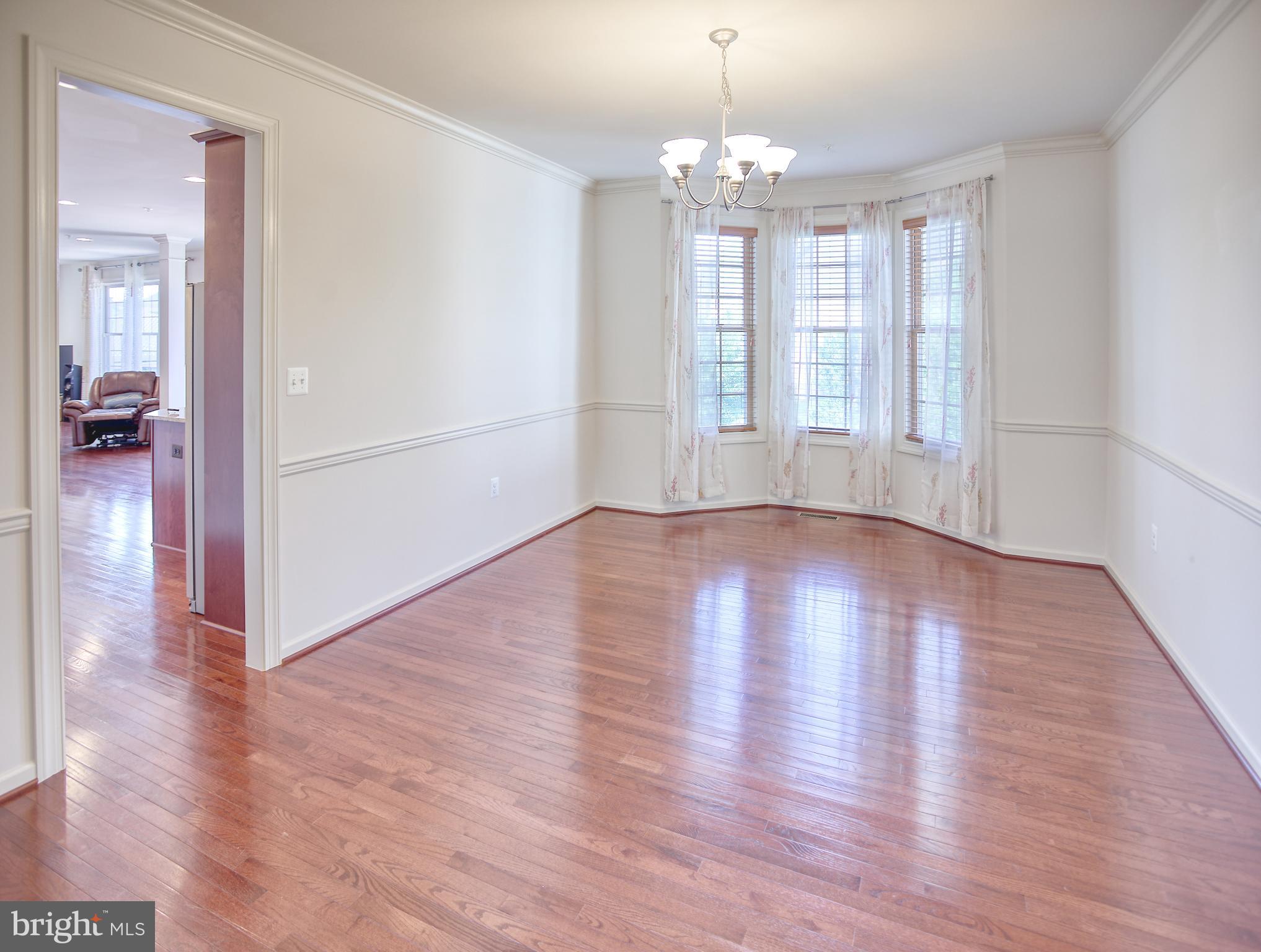 13336 Redspire Drive Silver Spring, MD 20906 - Photo 12 of 66 a view of empty room with wooden floor and fan