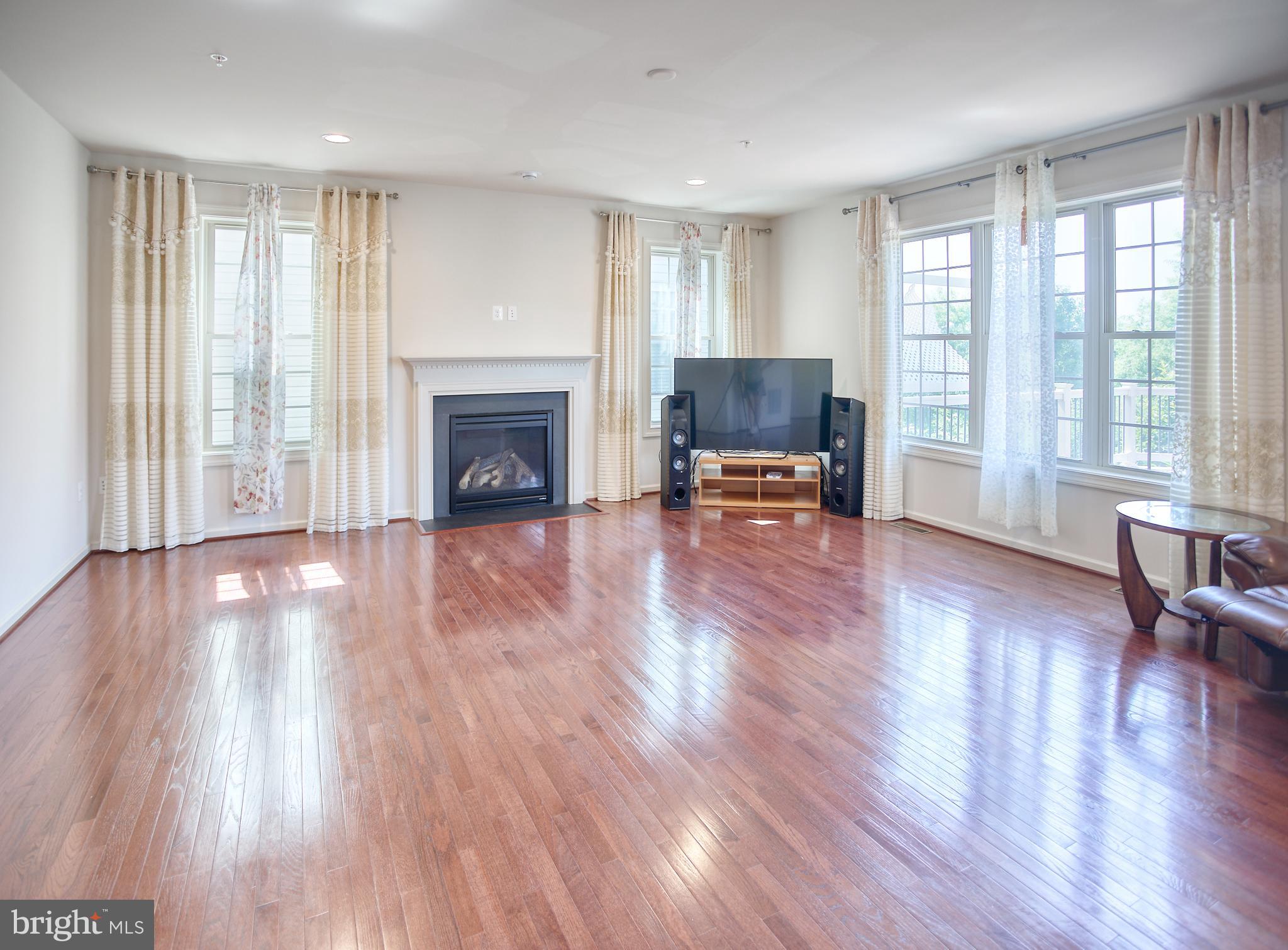 13336 Redspire Drive Silver Spring, MD 20906 - Photo 18 of 66 a view of a livingroom with furniture a fireplace and wooden floor