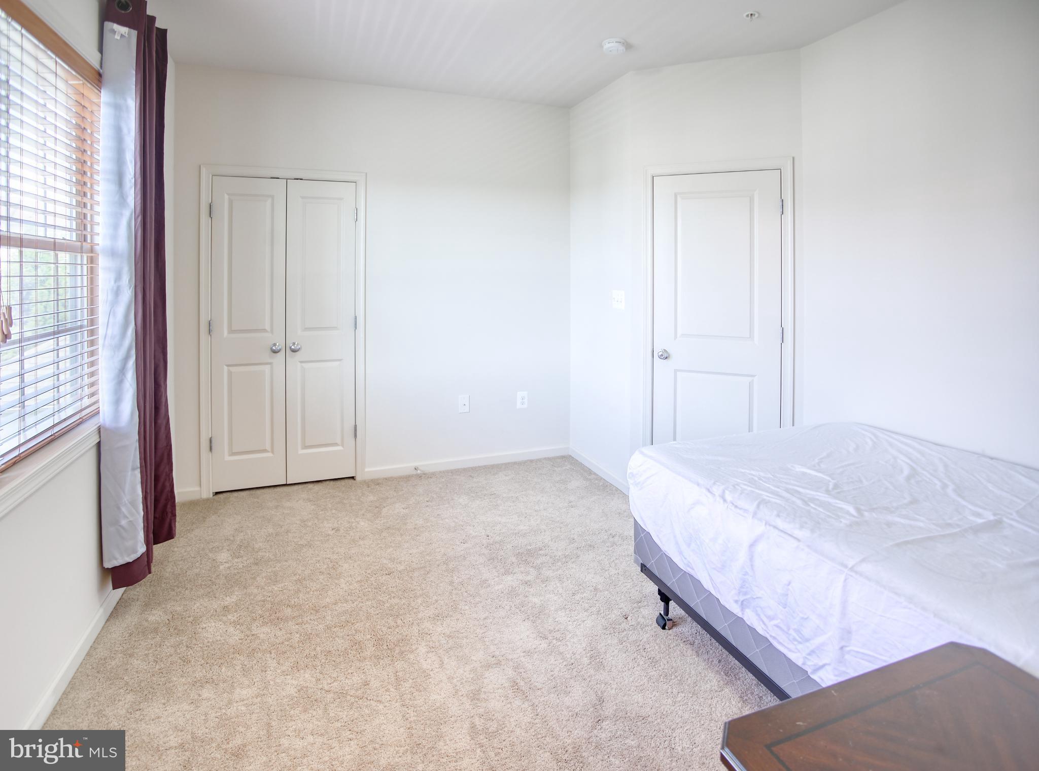 13336 Redspire Drive Silver Spring, MD 20906 - Photo 30 of 66 a bedroom with a bed and a window