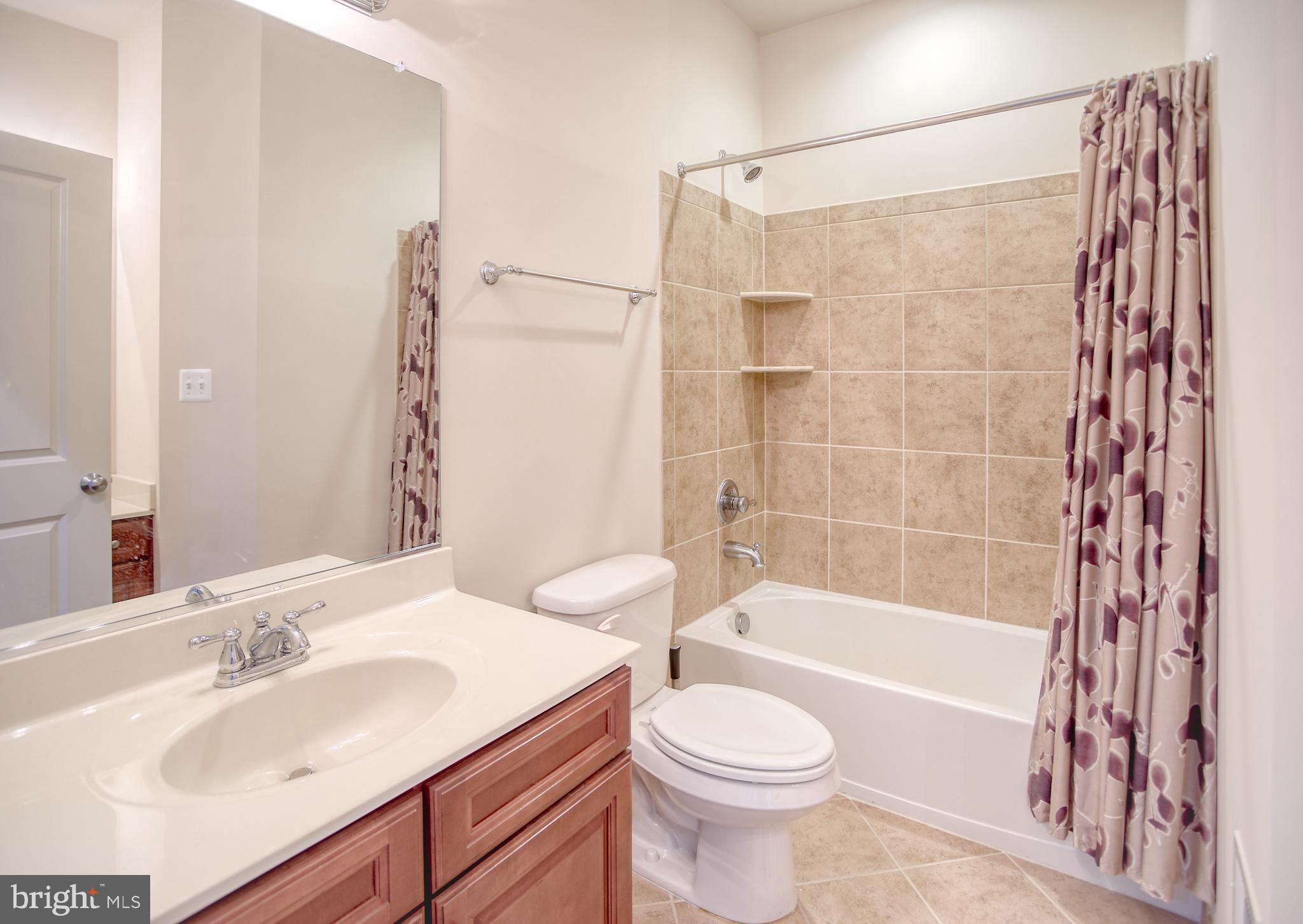 13336 Redspire Drive Silver Spring, MD 20906 - Photo 34 of 66 a bathroom with a sink a toilet and a bathtub